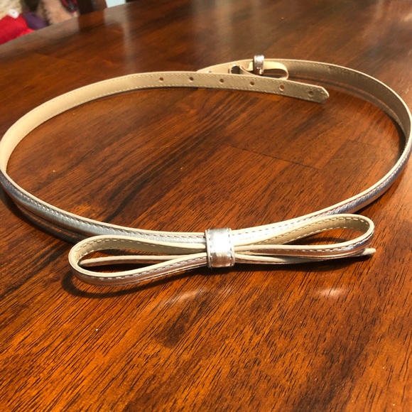 White House Black Market Accessories - White House Black Market silver bow belt, size M. Two post back closure.